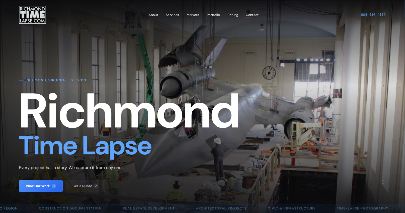 Full-screen website hero with cinematic project footage behind the headline